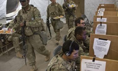 U.S. service members, including soldiers from the Army's 101st Airborne Division use computers and prepare to eat inside a tent at at a coalition air base in Qayara, some 50 kilometers south of Mosul, Iraq, Friday, Oct. 28, 2016. The U.S. military says Iraqi forces have retaken 40 villages from the Islamic State group near Mosul since a massive operation to drive the militants from the city began last week. It says Iraqi troops are consolidating gains made east and south of the city earlier this week, but i