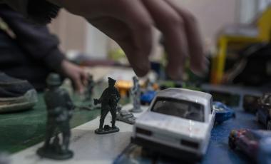 A boy plays with his toy soldiers inside a school that is being used as a shelter for people who fled the war, in Dnipro city, Ukraine, on Tuesday, April 12, 2022.