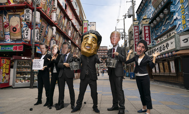 Environmental activists wear masks depicting world leaders during the G-20 Summit in Japan