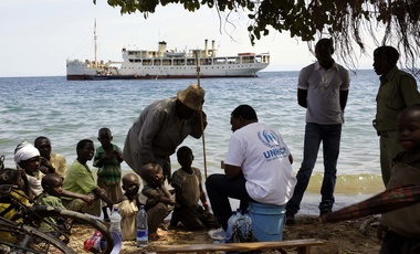 Refugees wait to board a UN ship