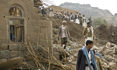 Yemenis stand amid the rubble of houses destroyed by Saudi-led airstrikes in a village near Sanaa, Yemen.