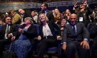 Britain's Prime Minister Liz Truss, center, smiles
