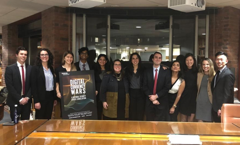 Members of the Belfer Center’s Economic Diplomacy Initiative gather after hosting “Digital Currency Wars,” a simulation of a live White House National Security Council meeting in response to a major security crisis. 