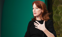 Meghan O'Sullivan speaking in front of a green background.